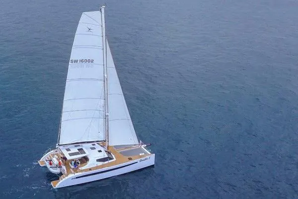 Slide: The Image of 2025 Seawind 1600 catamaran sailing on open ocean waters. - 23