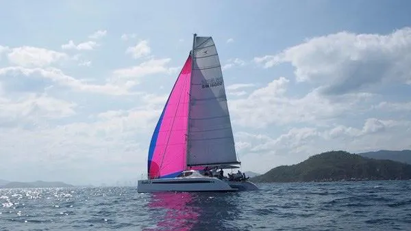 Slide: The Image of Sailing Seawind 1600 catamaran with vibrant sails on open water, 2025 model. - 31