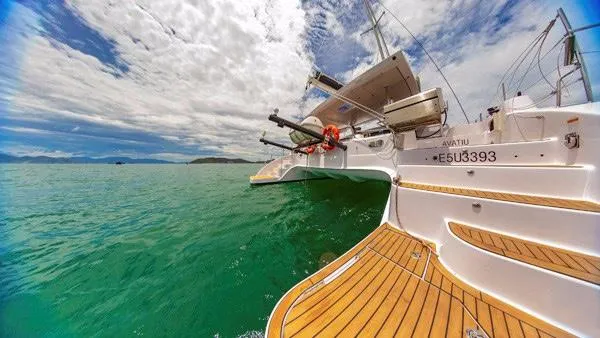 Slide: The Image of 2025 Seawind 1600 catamaran on turquoise waters under a partly cloudy sky. - 32