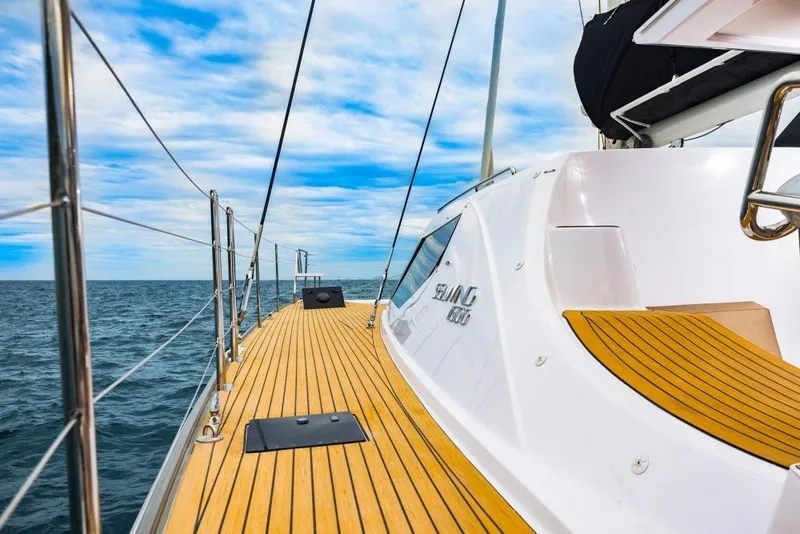 Slide: The Image of 2025 Seawind 1600 yacht with teak deck sailing on open sea. - 33