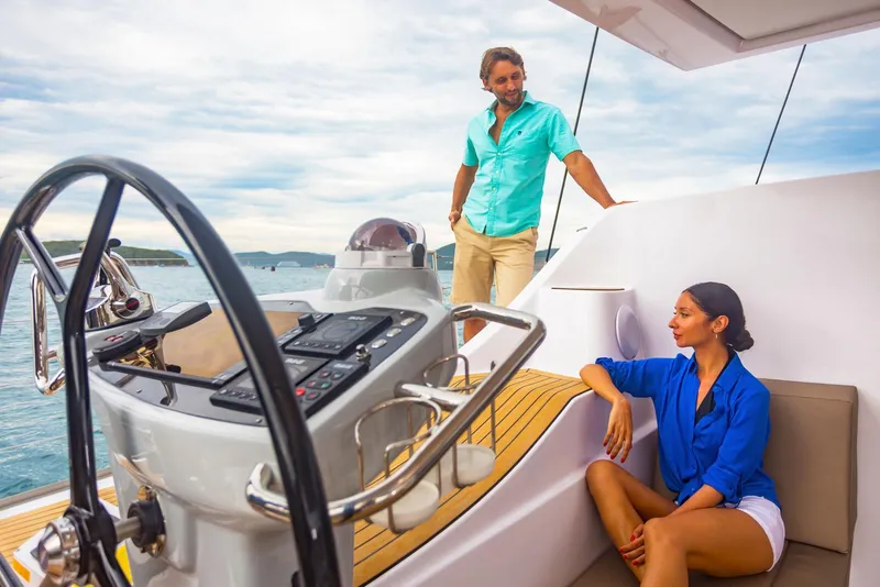 Slide: The Image of Couple enjoying a day on a 2025 Seawind 1600 yacht, with scenic ocean views. - 36