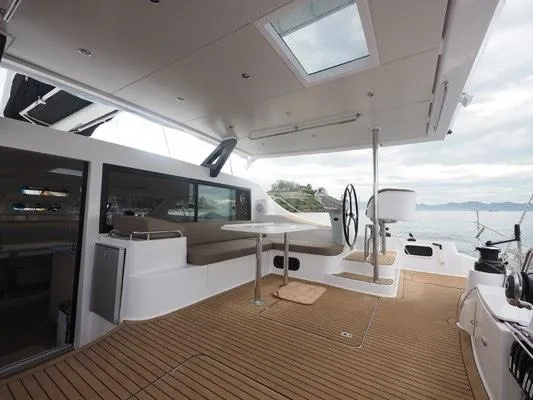 Slide: The Image of Spacious deck of 2025 Seawind 1600 catamaran with modern seating and steering wheel. - 38