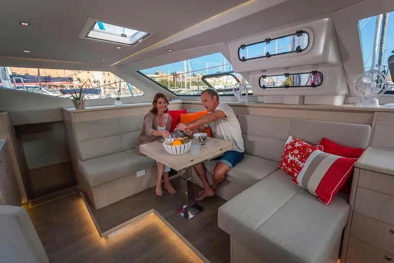 Slide: The Image of Couple enjoying a meal in the luxurious interior of a 2025 Seawind 1600 yacht. - 44