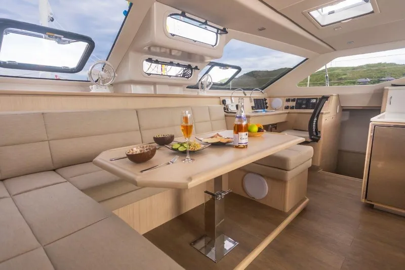 Slide: The Image of Luxurious interior of 2025 Seawind 1600 catamaran with dining area and panoramic windows. - 45