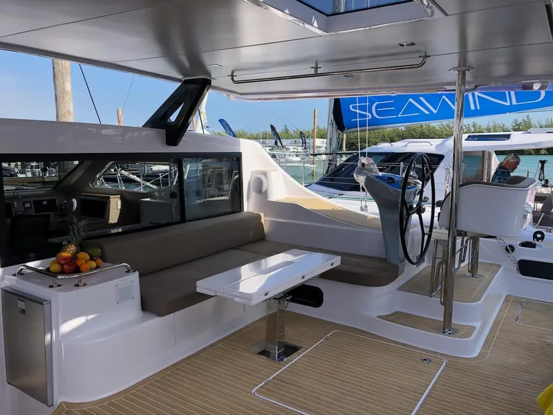 Slide: The Image of Luxurious 2025 Seawind 1600 catamaran interior with seating, table, and helm station. - 8