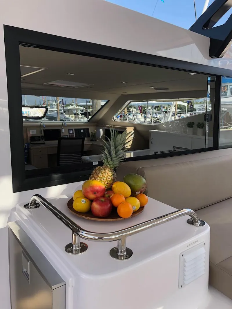 Slide: The Image of Seawind 1600 yacht interior with fruit bowl, 2025 model, featuring modern design and luxury amenities. - 9