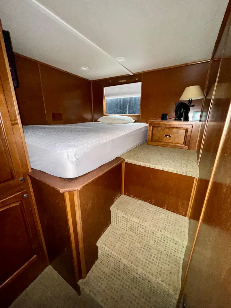 Slide: The Image of Cozy bedroom interior in 2011 Bravada Dreamweaver Trip #2 houseboat, featuring a bed and wooden decor. - 17