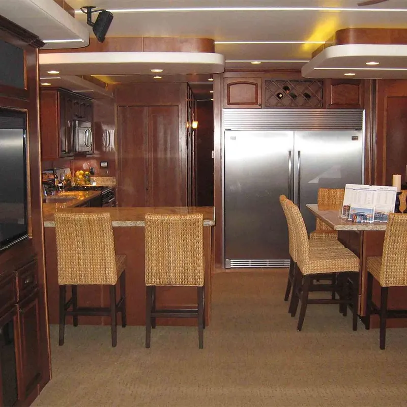 Slide: The Image of Luxurious kitchen interior in 2011 Bravada Dreamweaver Trip #2 with wooden cabinetry and bar seating. - 2