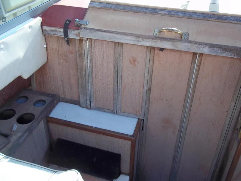 Slide: The Image of 1984 Sea Ray SRV 260 Sundancer interior with wooden paneling and storage compartments. - 12