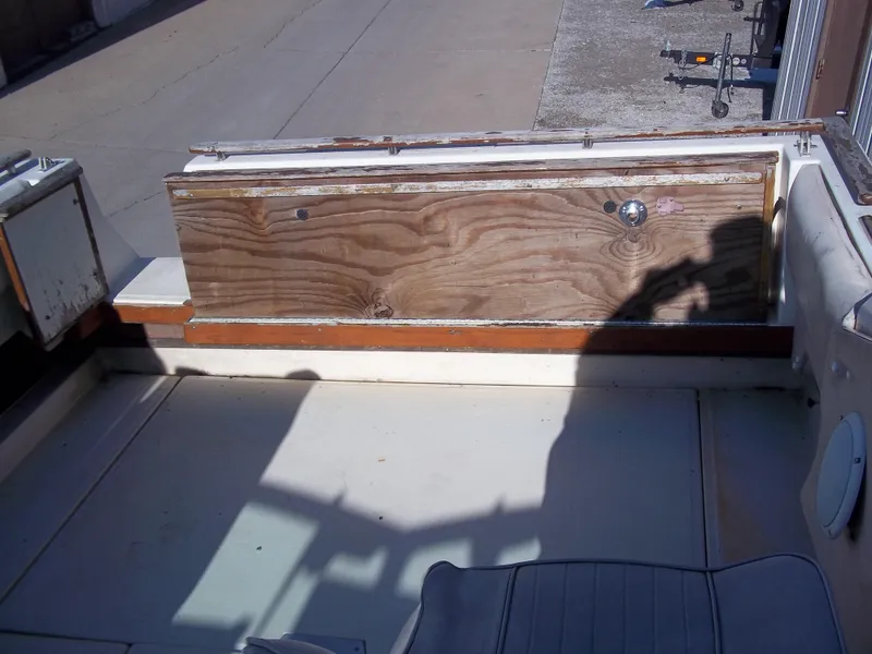 Slide: The Image of 1984 Sea Ray SRV 260 Sundancer boat interior with wooden panel and seating. - 14