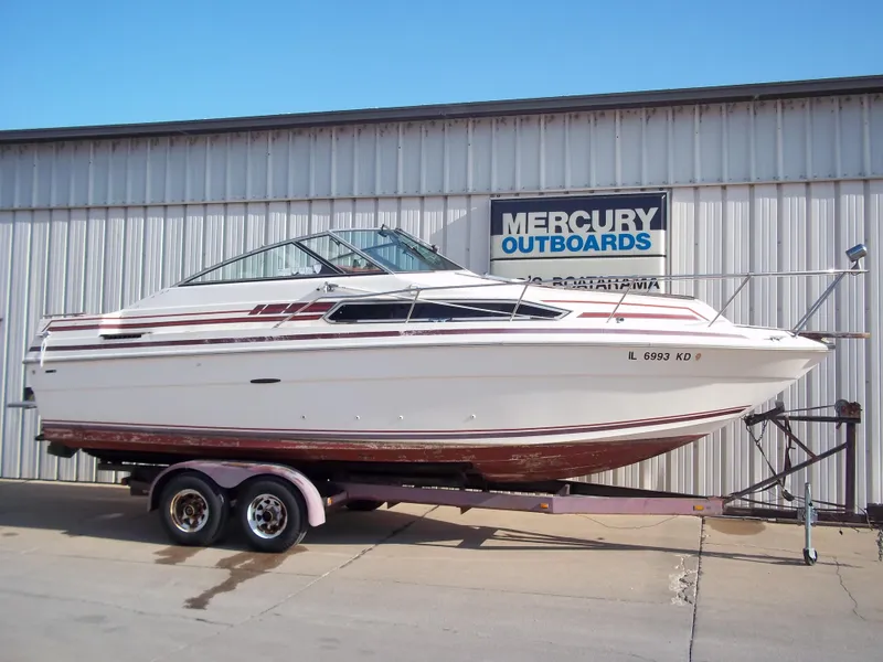 Slide: The Image of 1984 Sea Ray SRV 260 Sundancer boat on trailer outside Mercury Outboards building. - 2
