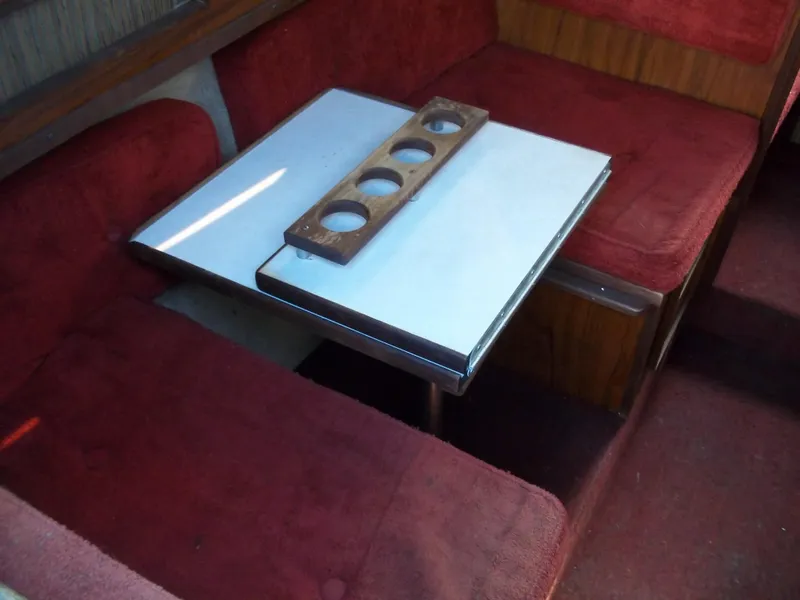 Slide: The Image of 1984 Sea Ray SRV 260 Sundancer interior with red seating and white table. - 20