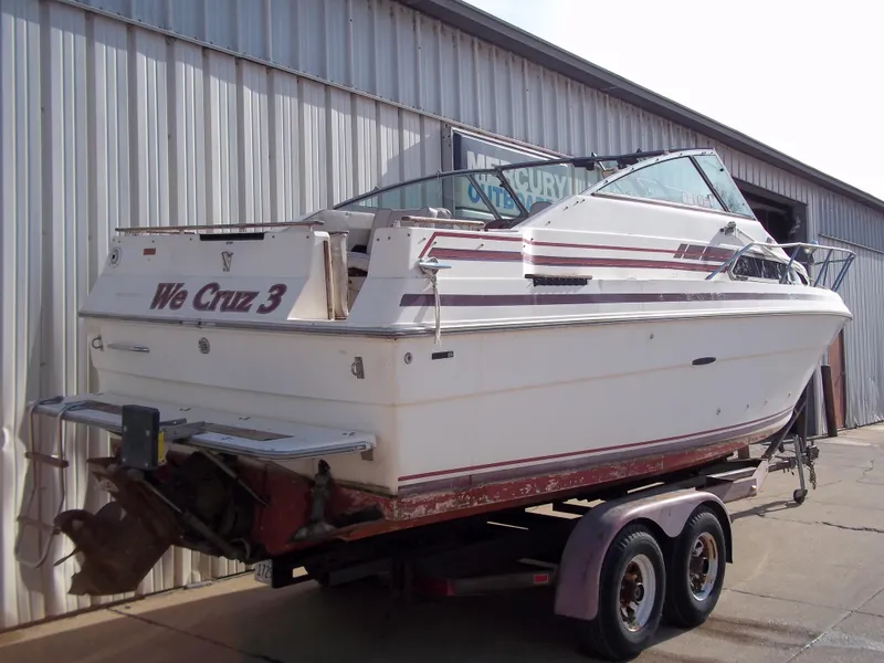 Slide: The Image of 1984 Sea Ray SRV 260 Sundancer boat on trailer outside metal building. - 26