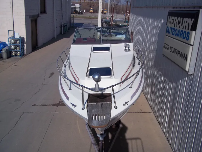 Slide: The Image of 1984 Sea Ray SRV 260 Sundancer boat docked at a marina. - 3