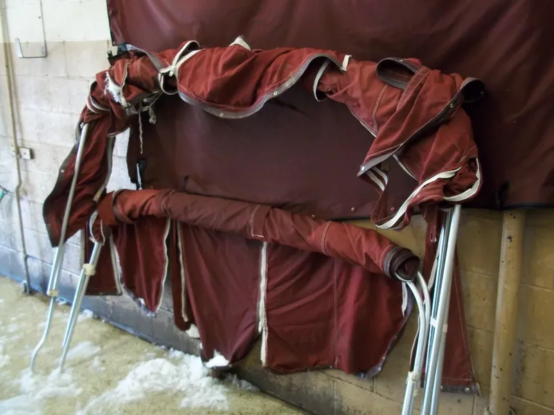Slide: The Image of 1984 Sea Ray SRV 260 Sundancer maroon boat cover and frame in storage. - 6