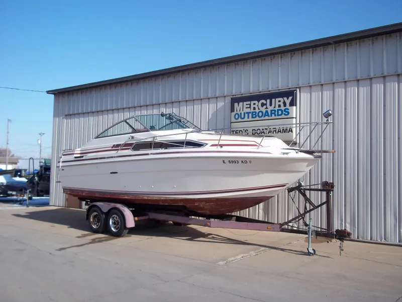 Slide: The Image of 1984 Sea Ray SRV 260 Sundancer boat on trailer outside Mercury Outboards building. - 8