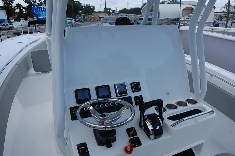 Slide: The Image of 2025 Cape Horn 32 XS boat dashboard with steering wheel and control panel. - 16