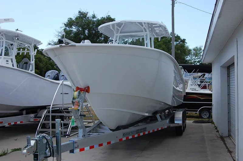 Slide: The Image of 2025 Cape Horn 32 XS boat on a trailer in a marina. - 23