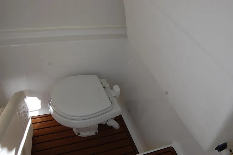 Slide: The Image of 2025 Cape Horn 32 XS boat bathroom with wooden floor and white toilet. - 8