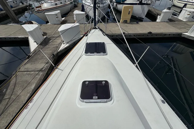 Slide: The Image of Bow view of a 2004 C&C 110 sailboat docked at a marina. - 10