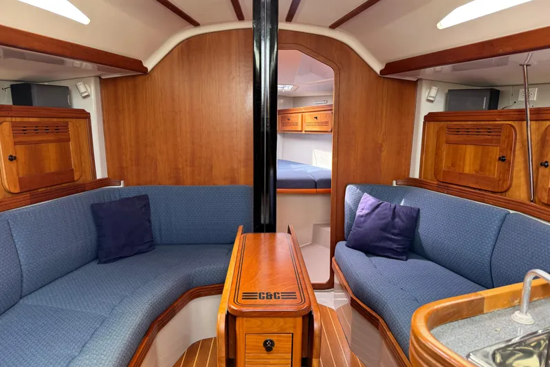 Slide: The Image of Luxurious interior of 2004 C&C 110 sailboat with blue seating and wooden finishes. - 14