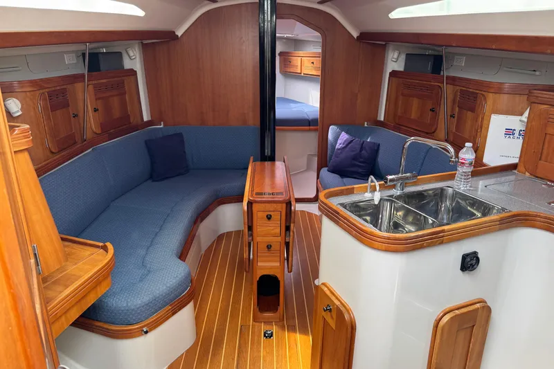 Slide: The Image of Interior of 2004 C&C 110 yacht with wooden finish and cozy seating area. - 19