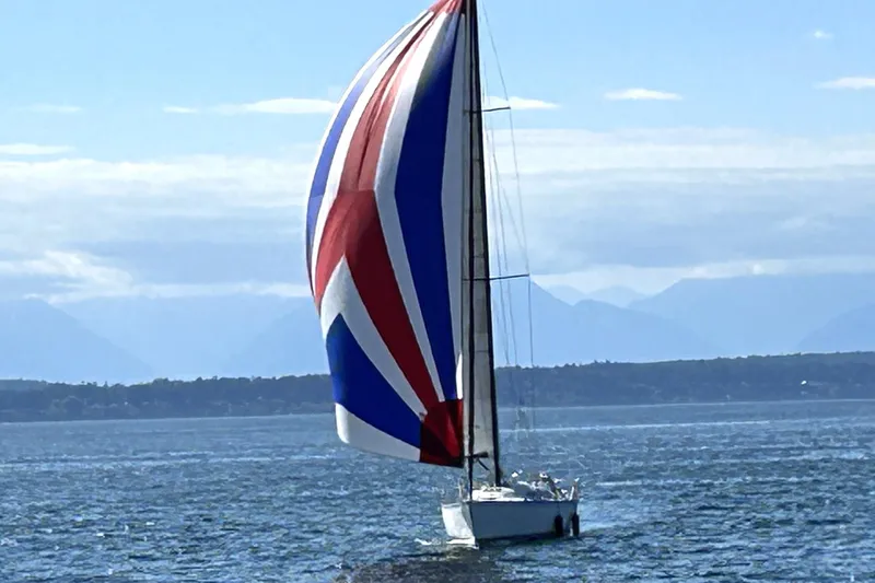 Slide: The Image of Sailboat with colorful spinnaker on open water, C&C 110 model, 2004. - 2