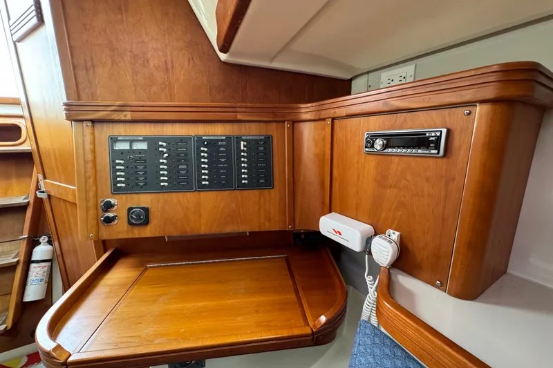 Slide: The Image of Wooden interior of a 2004 C&C 110 sailboat with control panel and radio system. - 25