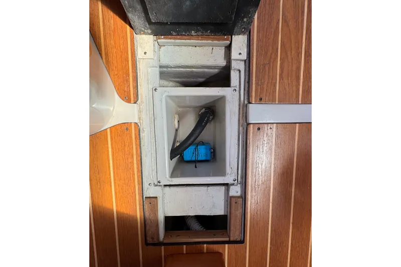 Slide: The Image of Interior view of a 2004 C&C 110 sailboat, featuring a storage compartment. - 28