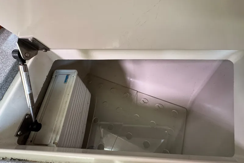 Slide: The Image of Open storage compartment in C&C 110 model, 2004, with hydraulic hinge and white interior. - 29