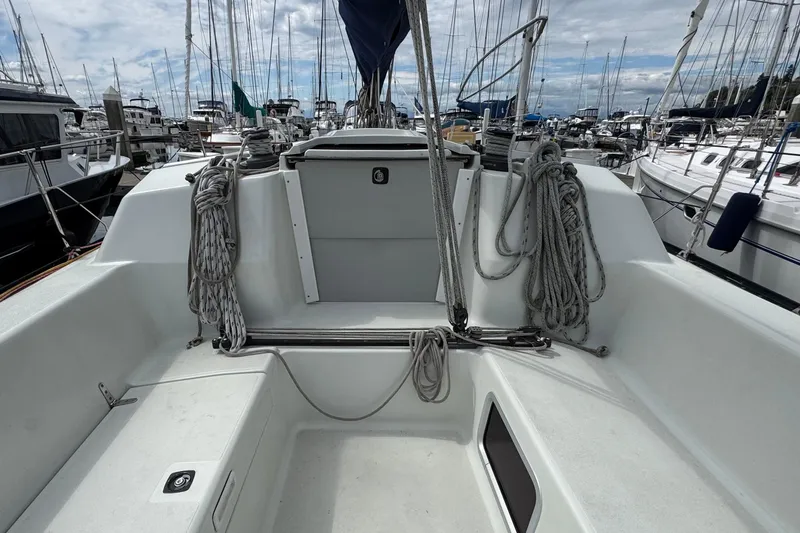 Slide: The Image of Cockpit of a 2004 C&C 110 sailboat, docked in a marina with rigging visible. - 3