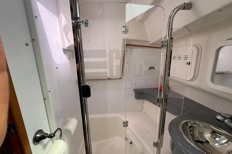 Slide: The Image of Modern yacht bathroom with glass shower, sleek sink, and elegant fixtures in a 2004 C&C 110 model. - 31