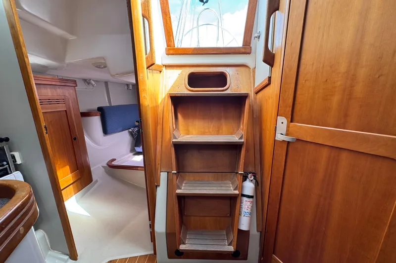 Slide: The Image of Interior of 2004 C&C 110 sailboat with wooden cabinetry and steps. - 32
