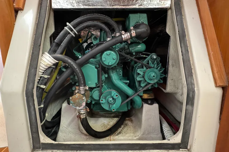 Slide: The Image of Engine compartment of a 2004 C&C 110 sailboat, featuring hoses and mechanical components. - 34