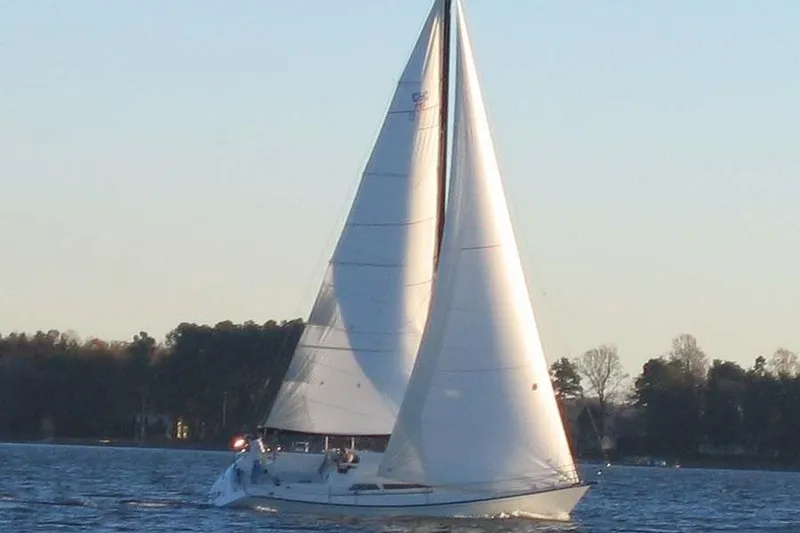 Slide: The Image of Sailboat on calm water, C&C 110 model, 2004, with trees in the background. - 39