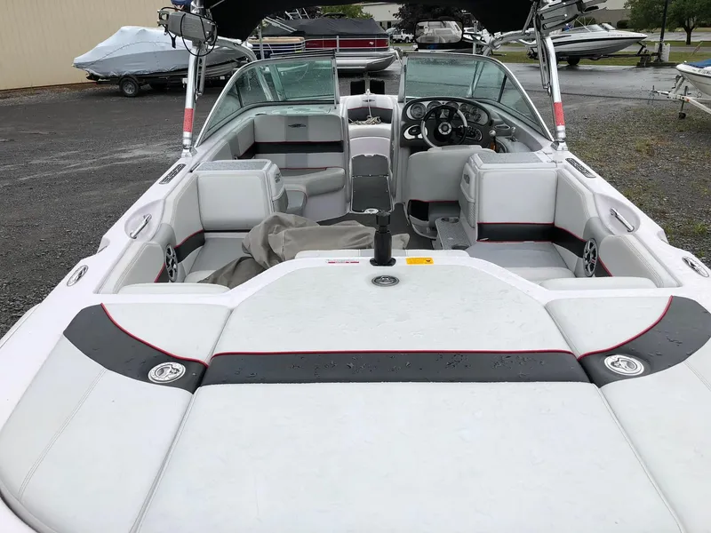 Slide: The Image of 2006 Correct Craft AIR NAUTIQUE 220 boat interior with seating and dashboard. - 4