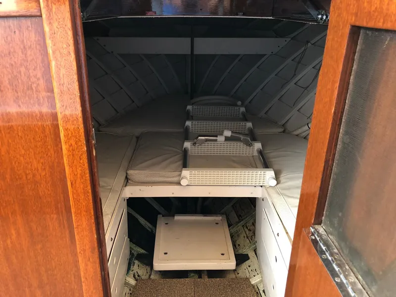 Slide: The Image of 1962 Lyman 245 boat interior with wooden finish and cushioned seating. - 10