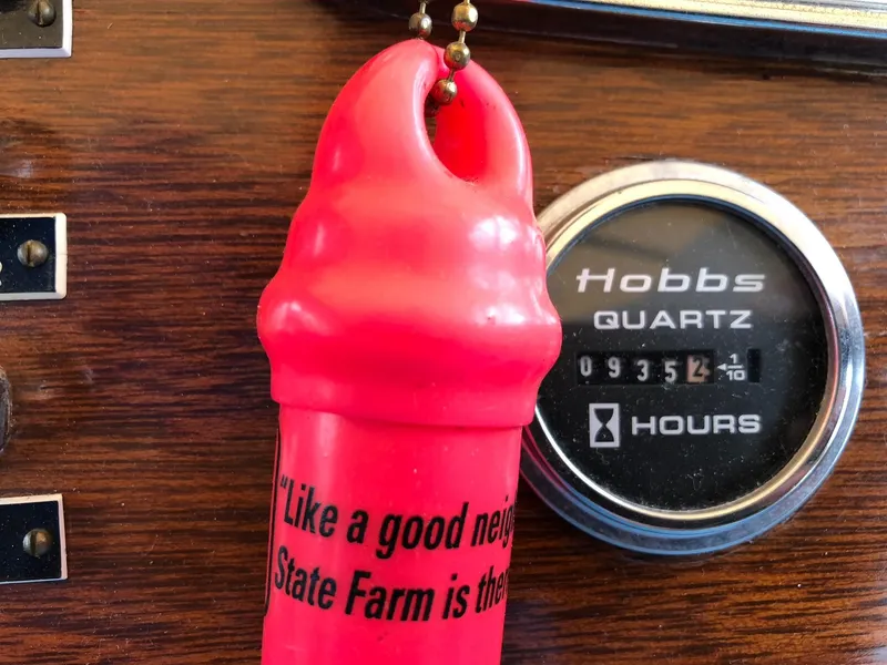 Slide: The Image of Red keychain with State Farm slogan beside Hobbs quartz hour meter. Lyman 245, 1962. - 13