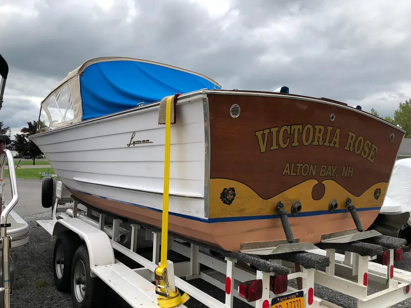 Slide: The Image of 1962 Lyman 245 boat "Victoria Rose" on trailer, Alton Bay, NH, with blue cover. - 3