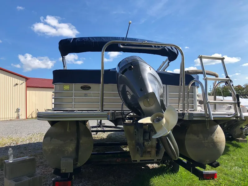 Slide: The Image of 2015 South Bay 522 FCR pontoon boat with outboard motor, parked outdoors. - 12