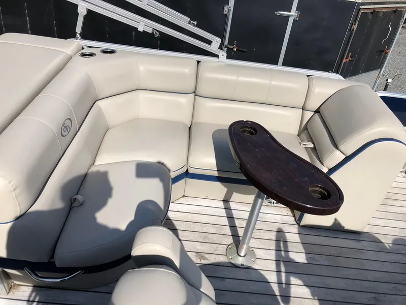 Slide: The Image of 2015 South Bay 522 FCR boat interior with beige seating and a small table. - 5