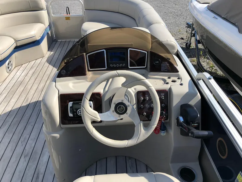 Slide: The Image of 2015 South Bay 522 FCR boat dashboard with steering wheel and control panel. - 6