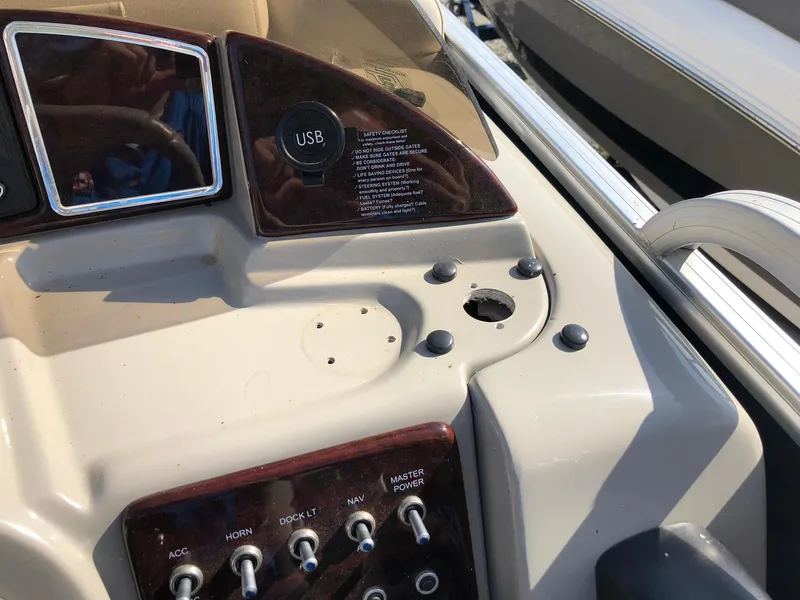 Slide: The Image of Control panel of a 2015 South Bay 522 FCR boat with USB port and switches. - 8