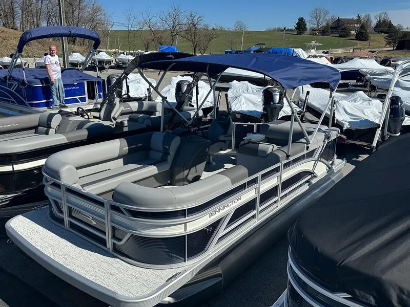 Slide: The Image of 2025 Bennington 20 SL pontoon boat with privacy room, displayed outdoors. - 11