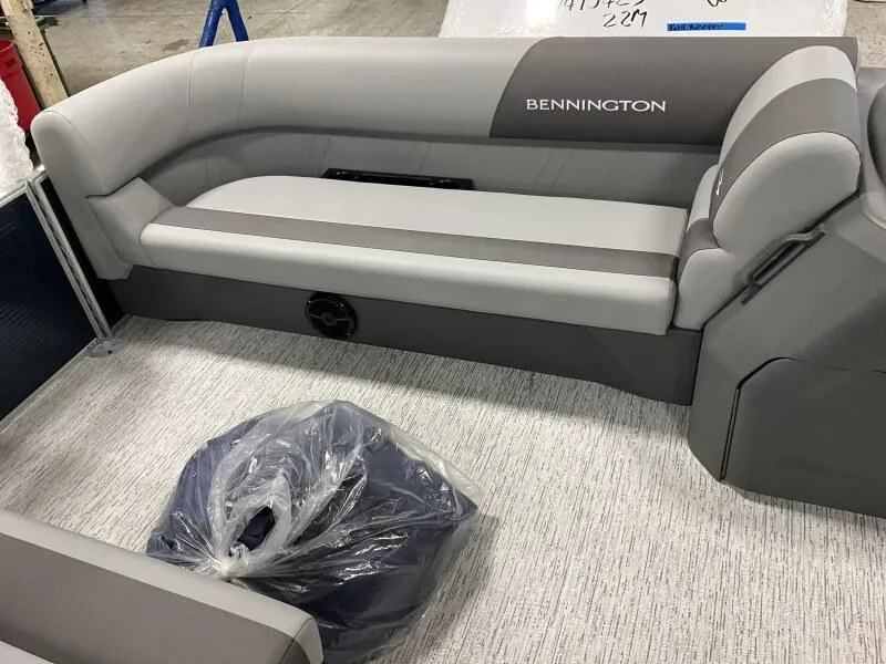 Slide: The Image of 2025 Bennington 20 SL Family pontoon boat interior with privacy room, featuring gray seating. - 15