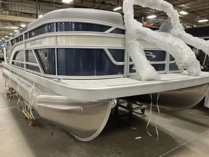 Slide: The Image of 2025 Bennington 20 SL Family pontoon boat with privacy room, in stock, displayed indoors. - 17