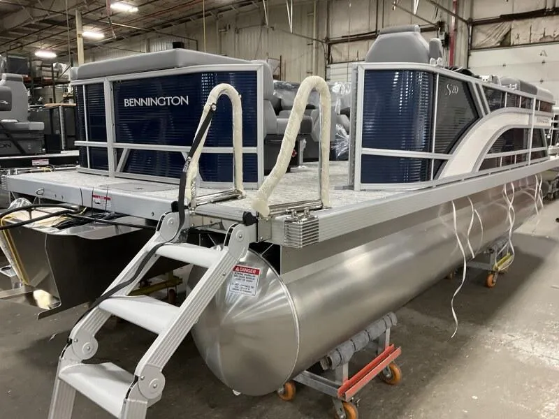 Slide: The Image of 2025 Bennington 20 SL Family pontoon boat with privacy room, in stock, in warehouse setting. - 18