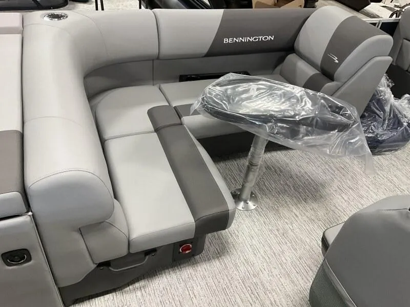 Slide: The Image of 2025 Bennington 20 SL Family boat interior with gray seating and table. - 20