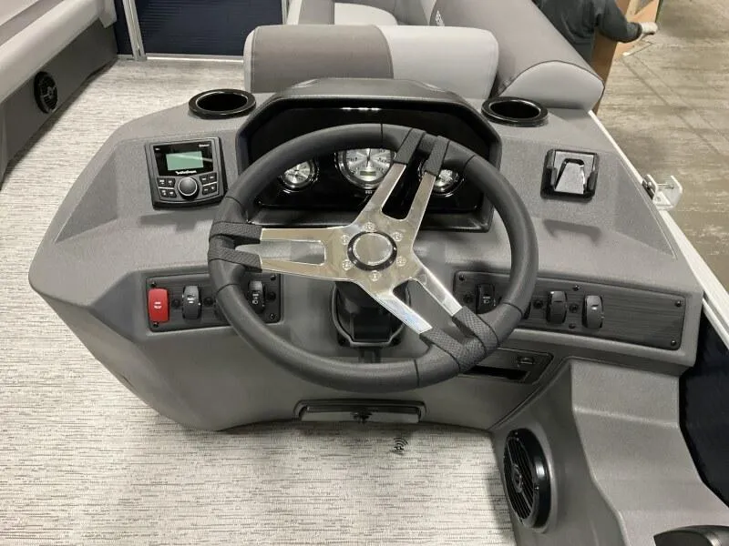 Slide: The Image of 2025 Bennington 20 SL Family boat dashboard with steering wheel and controls. - 21