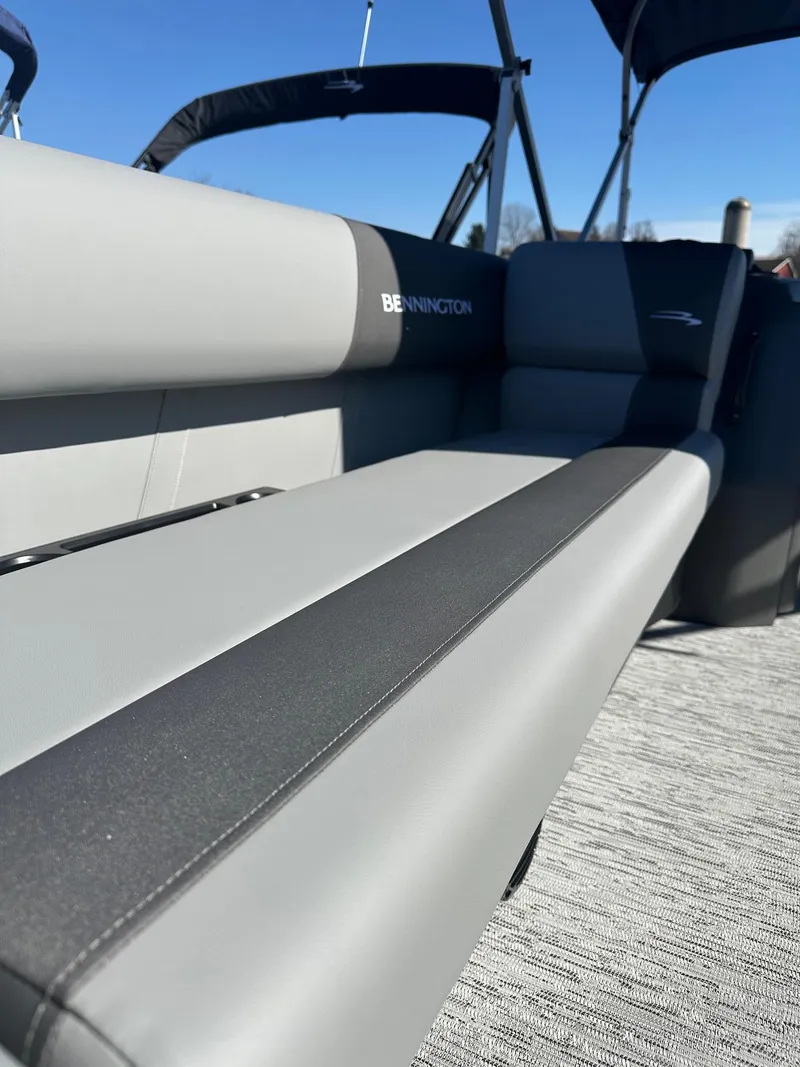 Slide: The Image of 2025 Bennington 20 SL Family boat interior with privacy room, featuring sleek gray seating. - 25